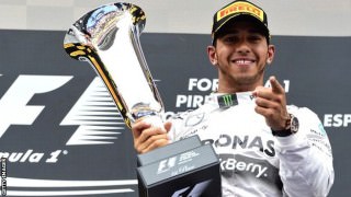 Lewis-Hamilton-with-a-trophy